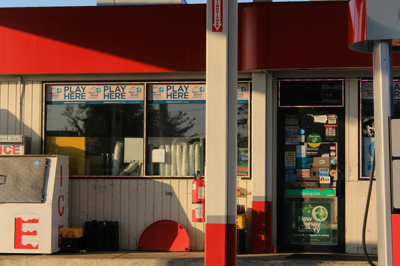 Storefront of a convenience store displaying lottery signage.